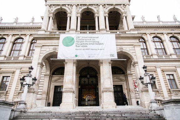 A huge conference banner decorates the main entrance of the university. 