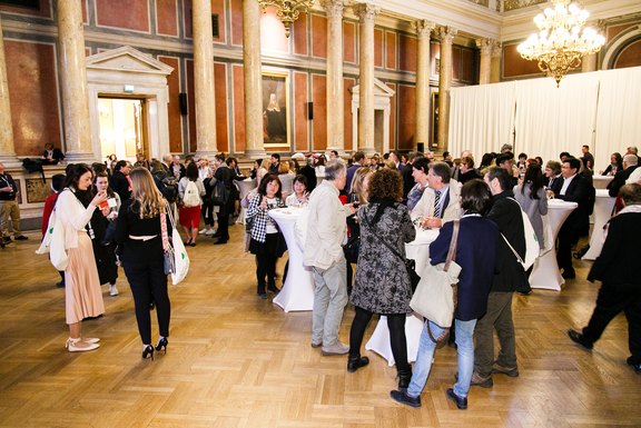 After the first plenary, the room for the welcome reception slowly fills with people 