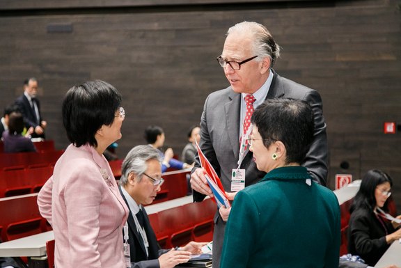 The chairs of plenary 2 with one of the speakers 